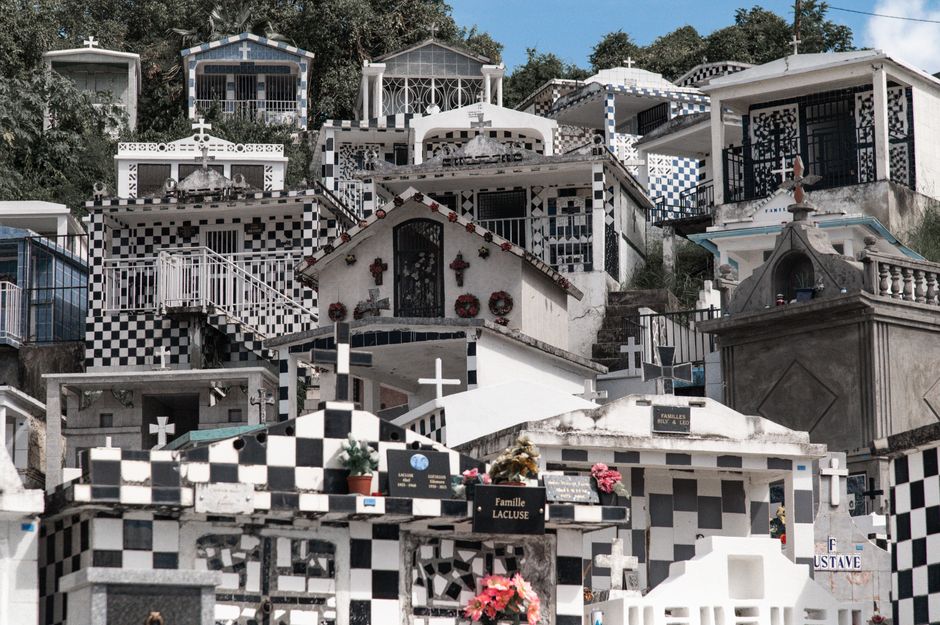 Morne-à-l'Eau Cemetery's striking black and white graves form a unique visual pattern.