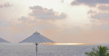 a couple of umbrellas sitting on top of a swimming pool