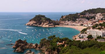 a view of a beach with boats in the water