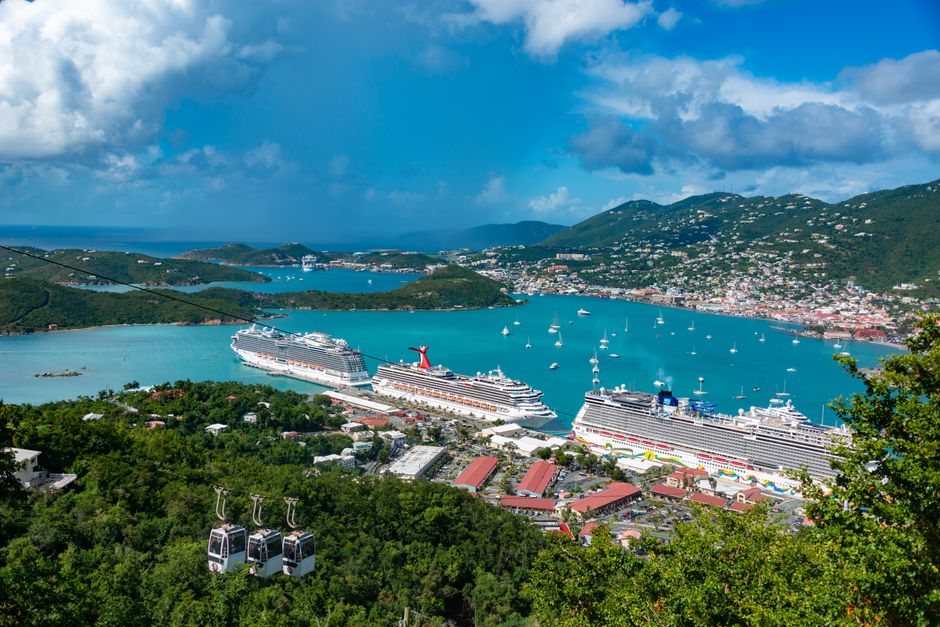 Aerial view of cruise ships docked in Charlotte Amalie Bay, Virgin Islands, under blue skies.