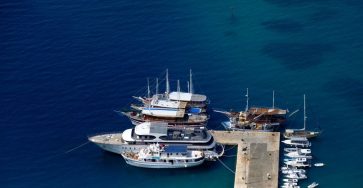 Discover the stunning aerial view of a marina in Croatia featuring boats and yachts docked at the pier.
