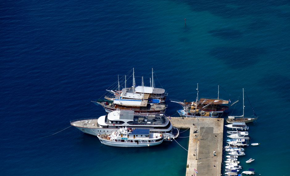 Discover the stunning aerial view of a marina in Croatia featuring boats and yachts docked at the pier.